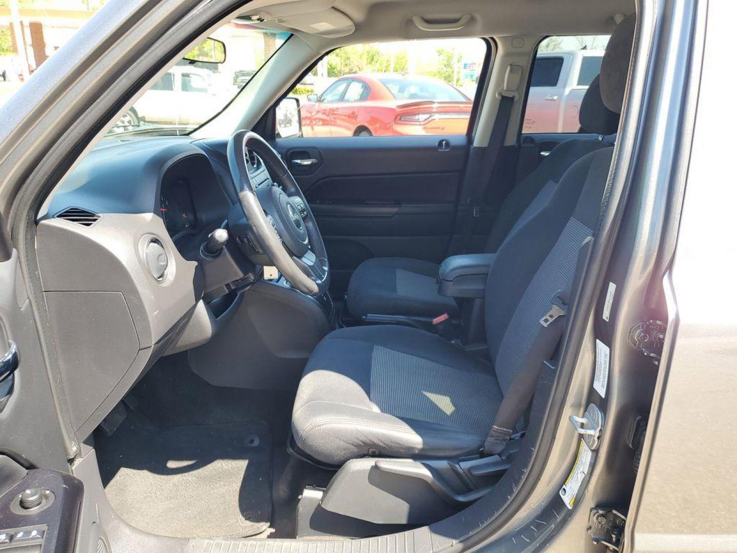 2013 Mineral Gray Metallic Clearcoat /Dark Slate Gray Jeep Patriot Latitude 4WD (1C4NJRFB5DD) with an 2.4L L4 DOHC 16V engine, CVT transmission, located at 234 Columbia Ave, Battle Creek, MI, 49015, (269) 222-0088, 42.298264, -85.192543 - When you encounter slick or muddy roads, you can engage the four wheel drive on this model and drive with confidence. Anti-lock brakes will help you stop in an emergency. The Jeep Patriot has a clean CARFAX vehicle history report. Maintaining a stable interior temperature in this vehicle is easy wit - Photo#7