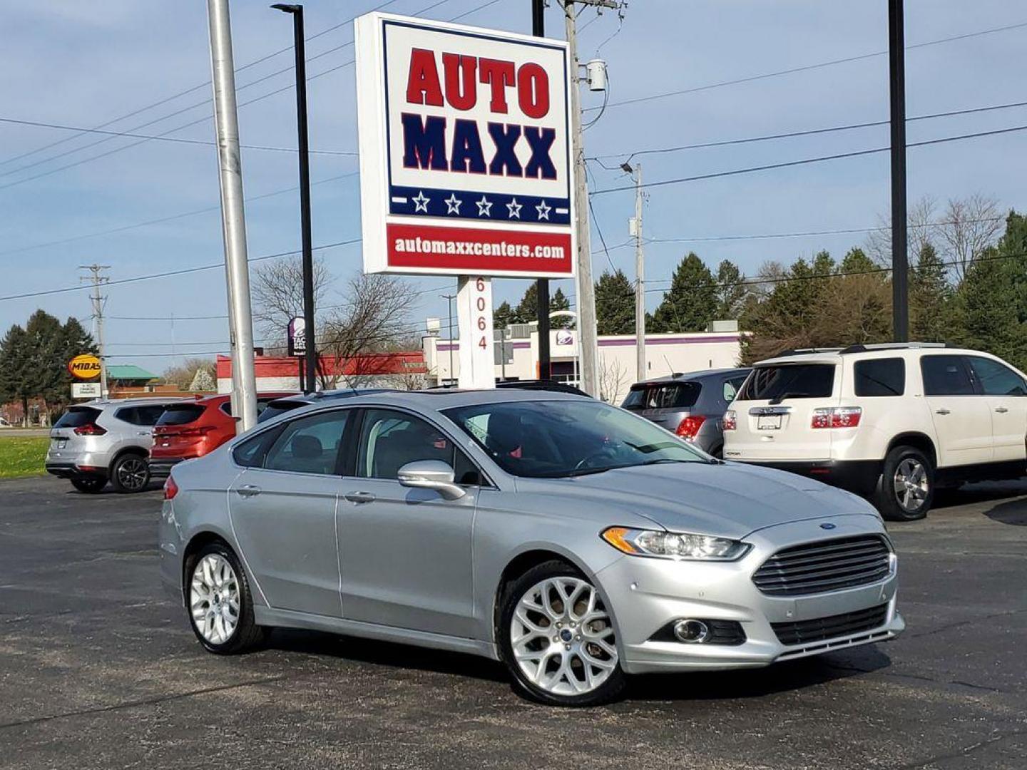 2014 Ingot Silver Metallic /Charcoal Black Ford Fusion Titanium AWD (3FA6P0D93ER) with an 2.0L L4 DOHC 16V engine, 6-speed automatic transmission, located at 6064 Gull Rd, Kalamazoo, MI, 49048, (269) 222-0088, 42.328388, -85.512924 - Discover the perfect blend of style, performance, and comfort with our 2014 Ford Fusion Titanium. This exceptional vehicle is equipped with all-wheel drive, ensuring confident handling and superior traction in all weather conditions. Under the hood, you'll find a robust 4-cylinder, 2.0L engine that - Photo#0