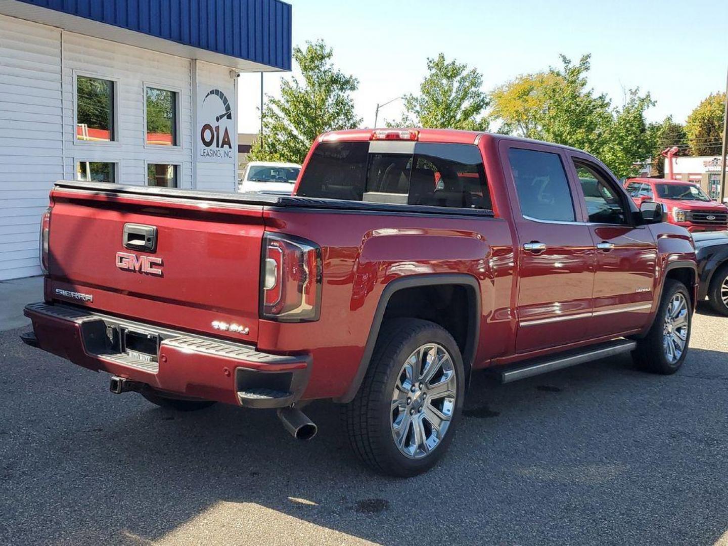 2018 Red Quartz Tintcoat /Jet Black GMC Sierra 1500 Denali Crew Cab Long Box 4WD (3GTU2PEJ9JG) with an 6.2L V8 OHV 16V engine, 6A transmission, located at 6064 Gull Rd, Kalamazoo, MI, 49048, (269) 222-0088, 42.328388, -85.512924 - <b>Vehicle Details</b><br>Discover the power and luxury of the 2018 GMC Sierra 1500 Denali at our dealership. This pre-owned gem comes equipped with a robust V8, 6.2L engine and 4WD, ensuring you have the muscle and traction needed for any adventure or tough job. Step inside to experience true com - Photo#1