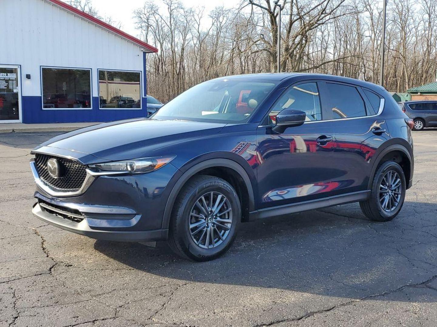 2021 Deep Crystal Blue Mica /Black Mazda CX-5 Touring (JM3KFACM6M0) with an 2.5L L4 DOHC 16V engine, 6A transmission, located at 234 Columbia Ave, Battle Creek, MI, 49015, (269) 222-0088, 42.298264, -85.192543 - <b>Vehicle Details</b><br>Experience the perfect blend of style, performance, and comfort with this pristine 2021 Mazda CX-5 Touring! With an impressive 0 miles on the odometer, this vehicle is practically brand new and ready to hit the road with you. The sleek design and dynamic curves of the Mazda - Photo#1