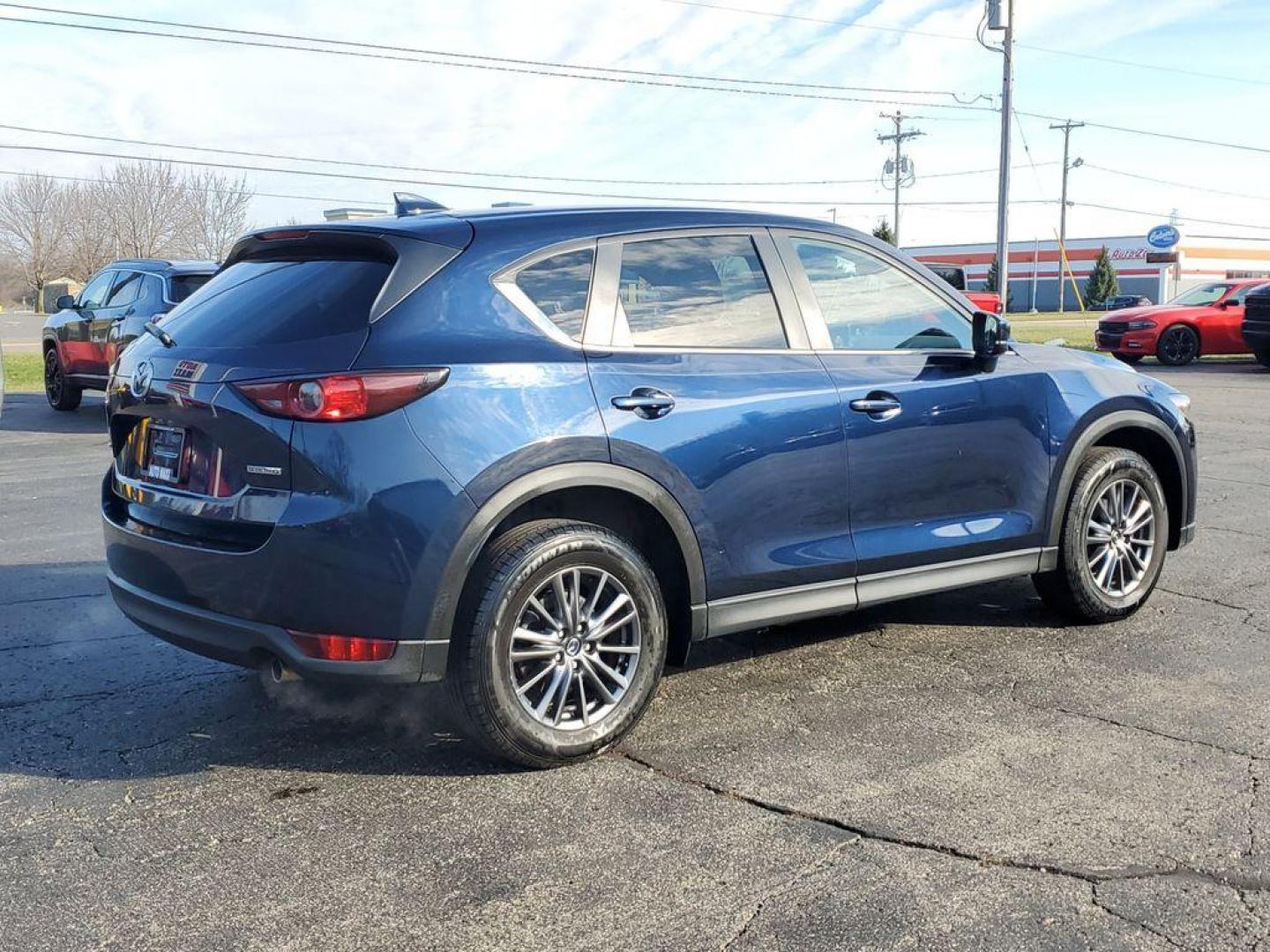2021 Deep Crystal Blue Mica /Black Mazda CX-5 Touring (JM3KFACM6M0) with an 2.5L L4 DOHC 16V engine, 6A transmission, located at 234 Columbia Ave, Battle Creek, MI, 49015, (269) 222-0088, 42.298264, -85.192543 - <b>Vehicle Details</b><br>Experience the perfect blend of style, performance, and comfort with this pristine 2021 Mazda CX-5 Touring! With an impressive 0 miles on the odometer, this vehicle is practically brand new and ready to hit the road with you. The sleek design and dynamic curves of the Mazda - Photo#3