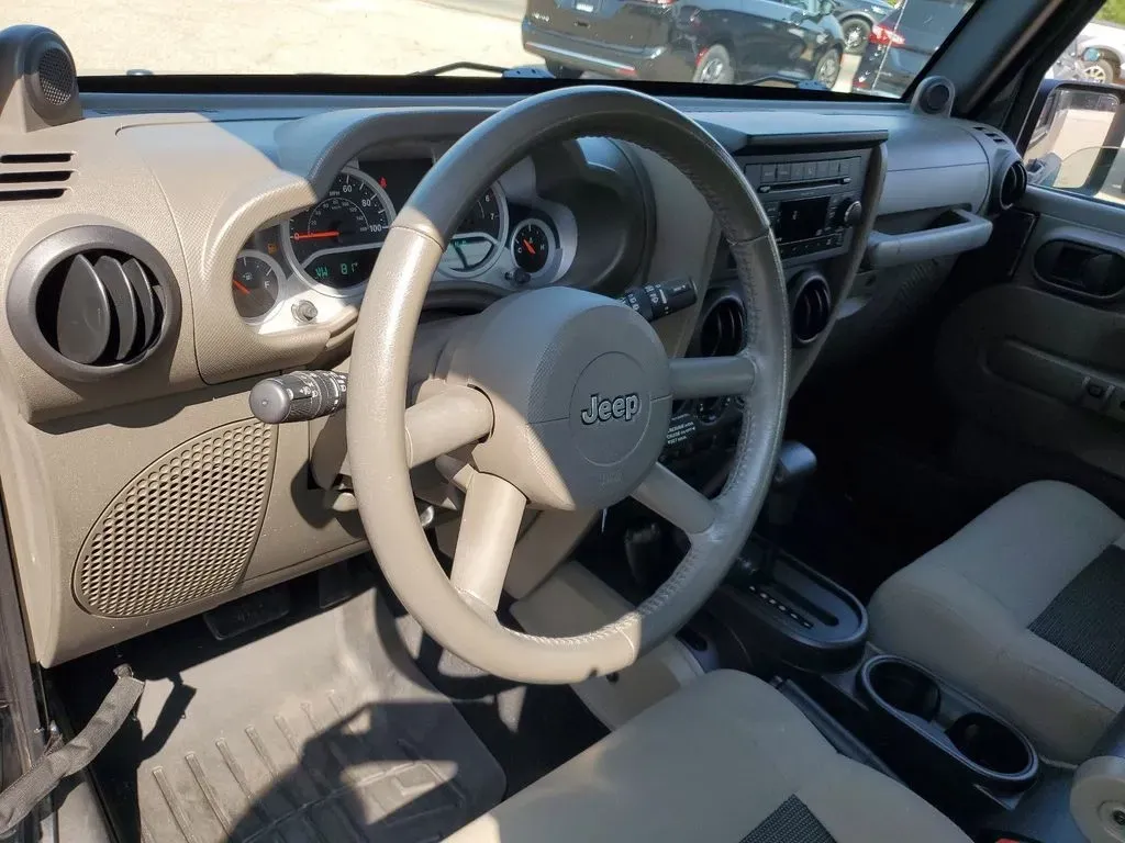 2010 Gray /Dark Khaki/Medium Khaki Jeep Wrangler Rubicon (1J4BA6D15AL) with an V6, 3.8L engine, 4-speed automatic transmission, located at 6064 Gull Rd, Kalamazoo, MI, 49048, (269) 222-0088, 42.328388, -85.512924 - Adventure awaits with our remarkable 2010 Jeep Wrangler Rubicon 4WD, a vehicle that embodies freedom and exploration. Whether you're looking to tackle rugged terrains on weekend getaways or navigate the urban jungle with style, this SUV is your perfect companion. With its iconic design and robust fe - Photo#13