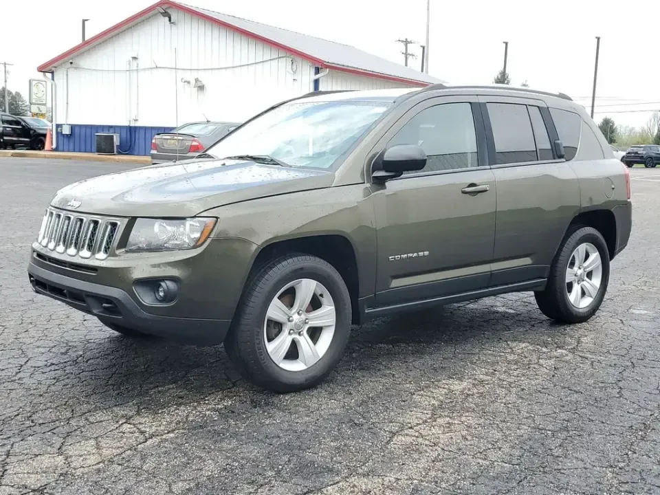2015 /Dark Slate Gray Jeep Compass Sport (1C4NJDBB8FD) with an 4 Cyl, 2.4L engine, 5-speed manual transmission, located at 6064 Gull Rd, Kalamazoo, MI, 49048, (269) 222-0088, 42.328388, -85.512924 - Weekend trailheads, snowy commutes, and spontaneous road trips up to Lake Michigan all get easier when you've got a compact SUV that's ready for real life. This **2015 Jeep Compass Sport 4WD** is built for drivers who want everyday practicality with the confidence to handle Michigan weather-whether - Photo#1